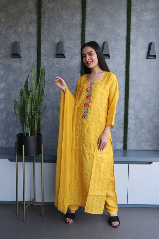 elegant silk ensemble in mustard yellow with intricate multicolor thread detailing